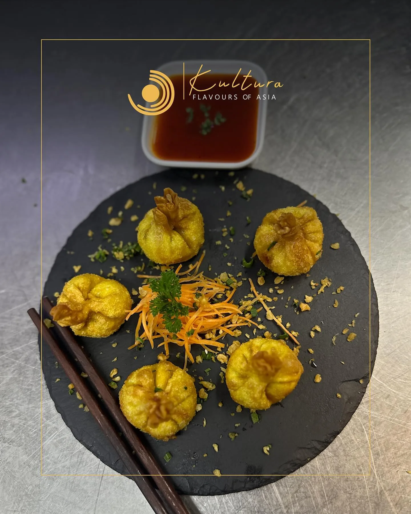 Dumplings plated on black stone at Kultura