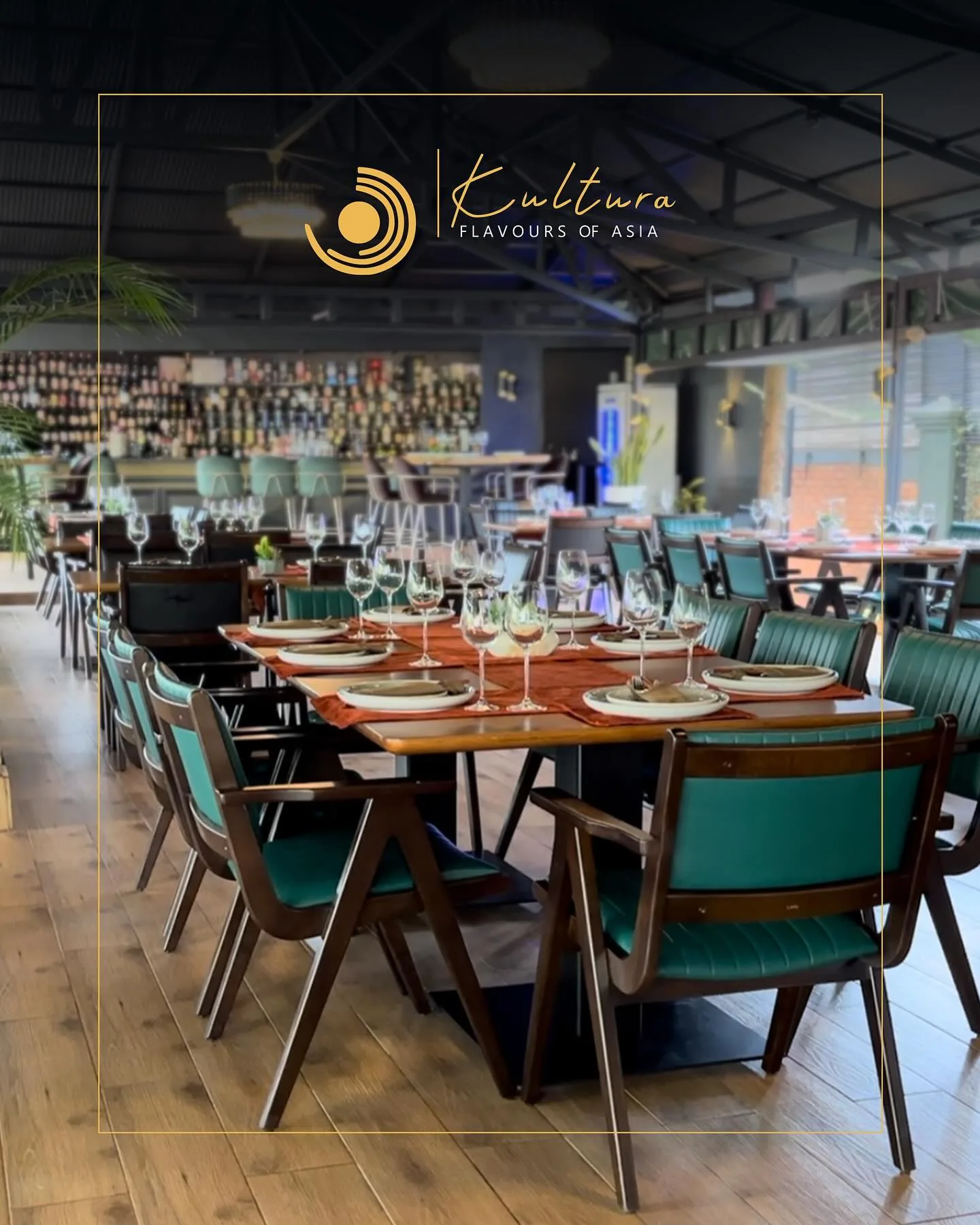 The Kultura dining room, low lit, laid for evening service